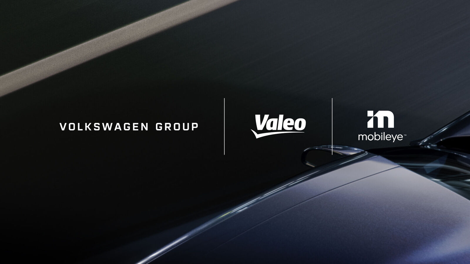 Image featuring the logos of Volkswagen Group, Valeo, and Mobileye above the front of a moving vehicle, captured from a top-down perspective on a dark road.